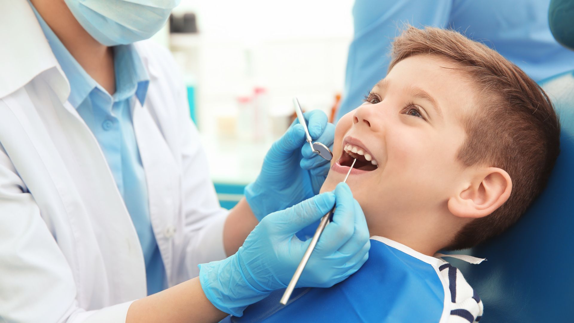 Dentist Checking Boy's Teeth Before Removal