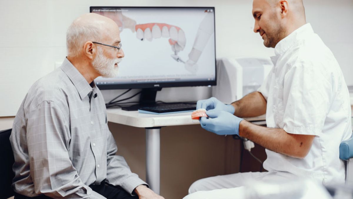 Dentist Explaining Dental Bridge Vs Dental Implant