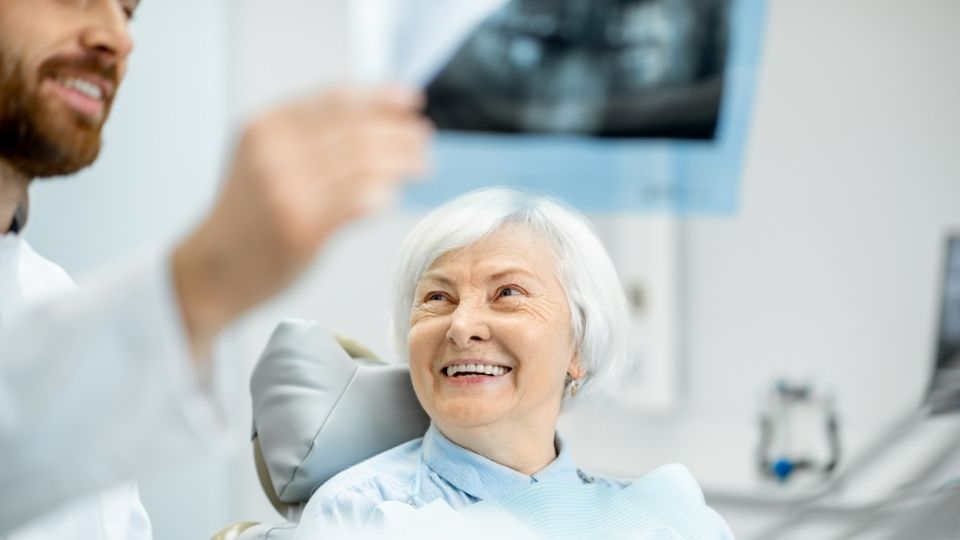 Patient Seeing A Dental X-ray Displayed By The Doctor