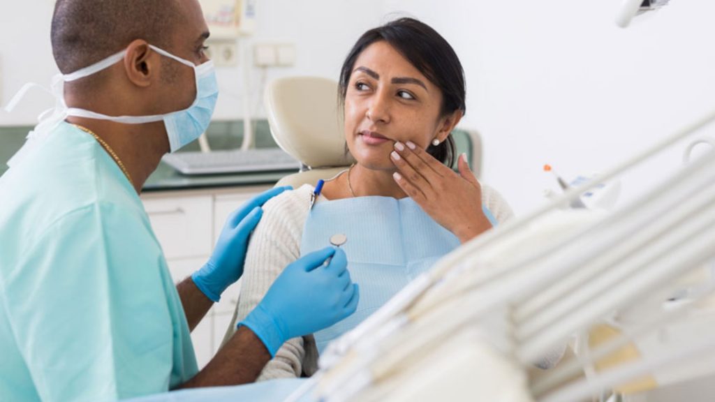 Dentist Consulting Patient About Tooth Decay